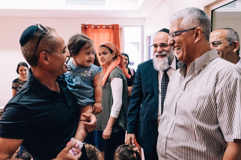 Gideon Shalom and Kalman Samuels, Founder and Chairman of Shalva with parents
